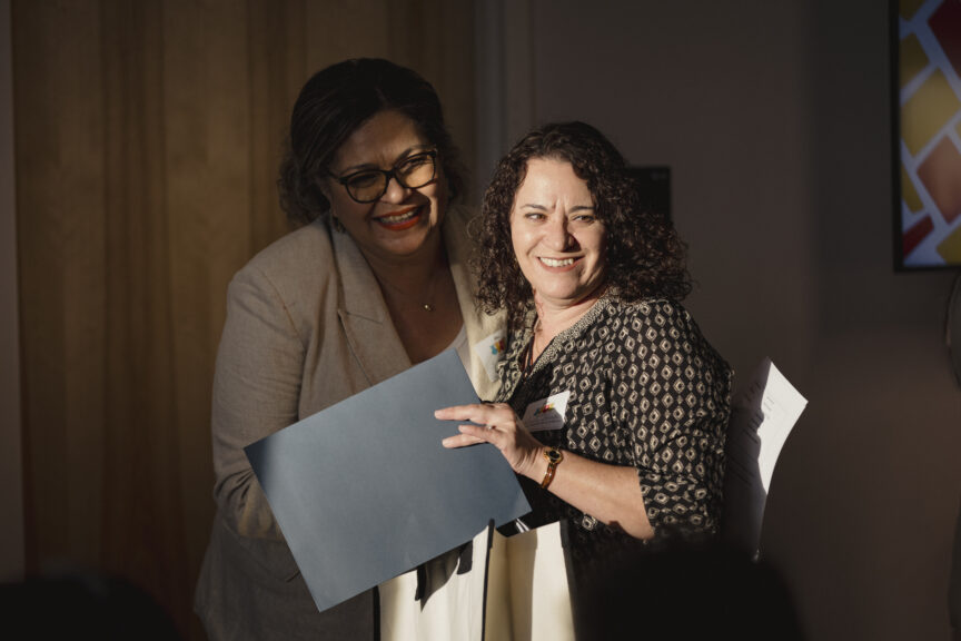 Rosalia smiling and holding a diploma